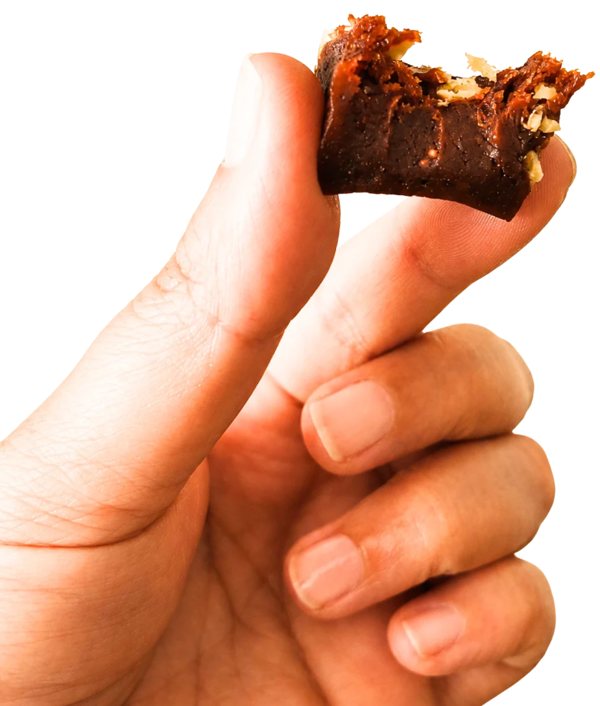 A bitten PepCubes cube held between two fingers